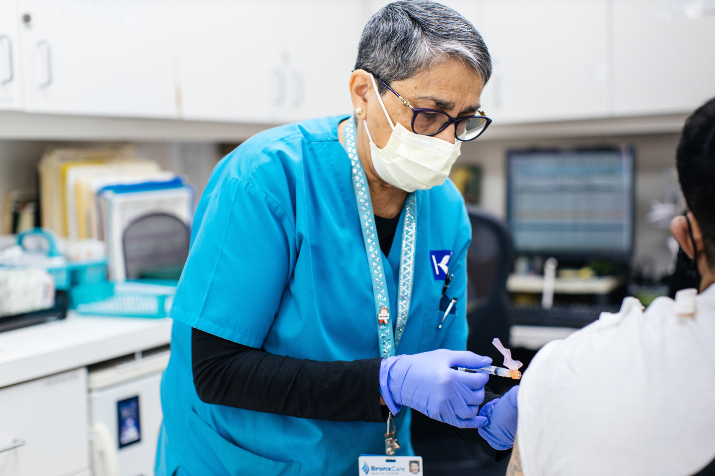 Rosa Rodriguez, LPN, administering COVID-19 vaccine at Ogden Family Medical and  Dental.