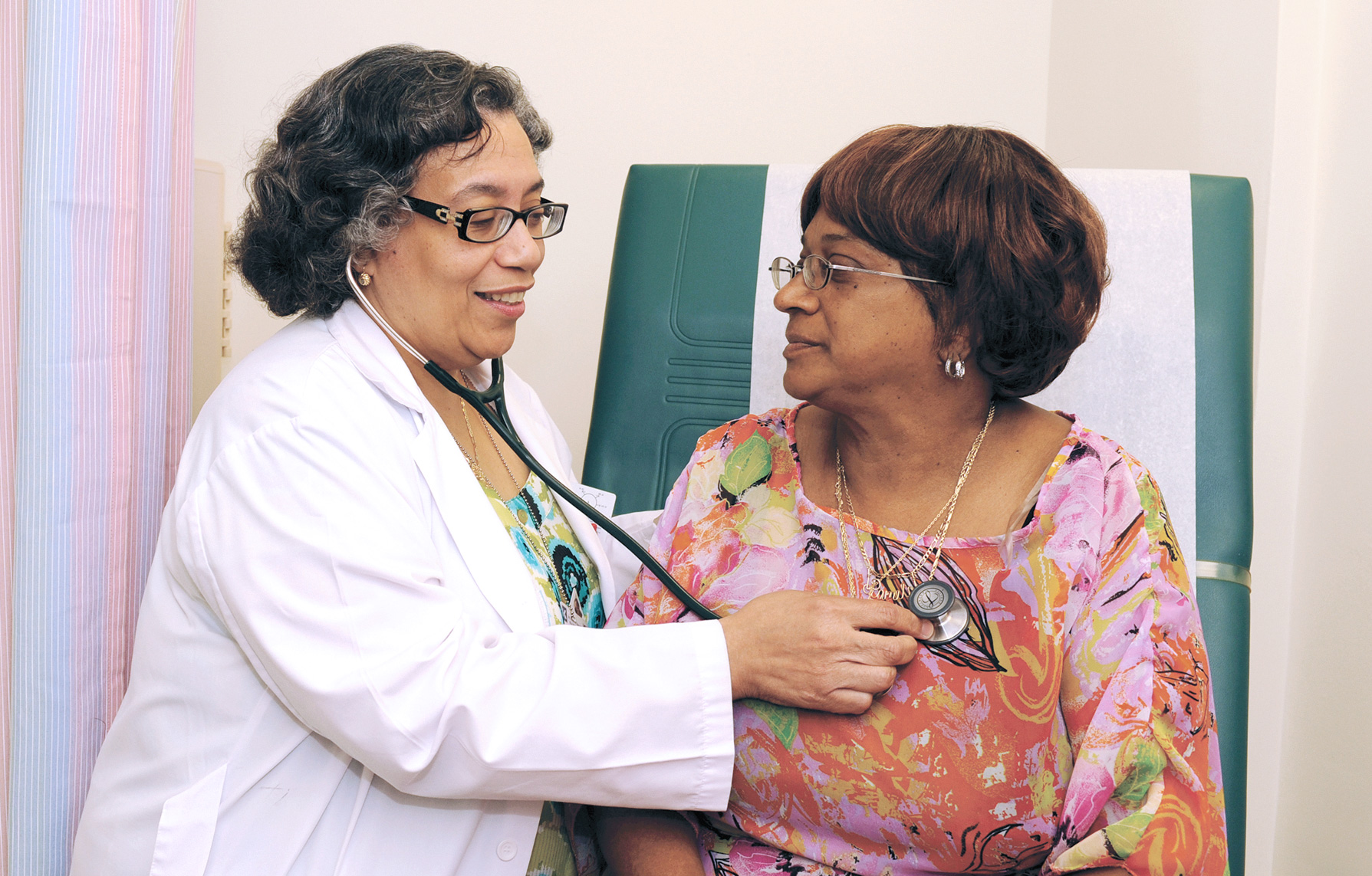 Dr. Yvonne Cruz, Medical Director, BronxCare Dr. Martin Luther King, Jr. Medical and Dental at Poe, examining patient. 