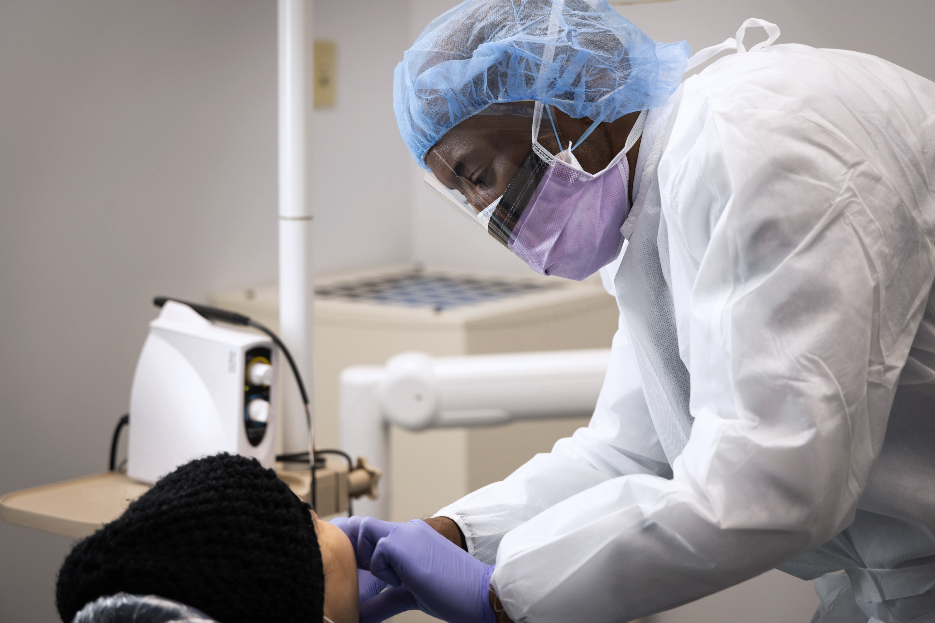 Dr. Emmett Robinson, Attending, Dentistry, treating patient at BronxCare Medical and Dental at Poe.