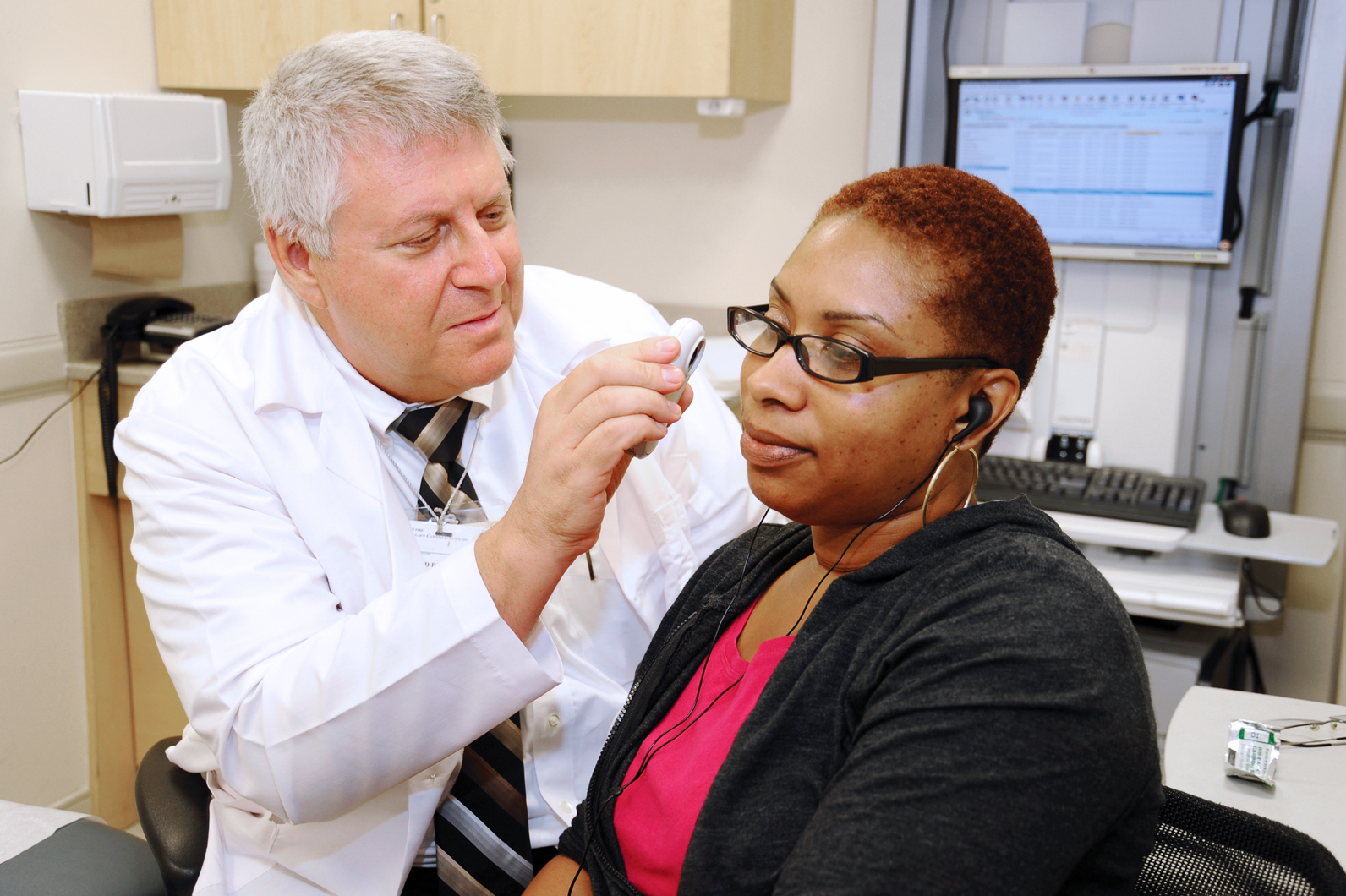 Dr. Donald Rudikoff, Chief, Dermatology, examining patient at BronxCare Third Avenue Practice. 