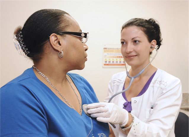 Photo: Dr. Fjona Fundo, Attending, Medicine, examining patient at BronxCare Third Avenue Practice.